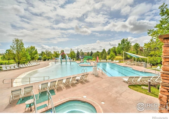 2384 Ponderosa Pl, Erie, CO 80516 - community pool featuring a water slide, a community hot tub, and a patio