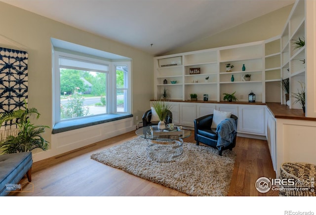 419 Centennial Dr, Louisville, CO 80027 - sitting room with wood finished floors, lofted ceiling, and a wall unit AC