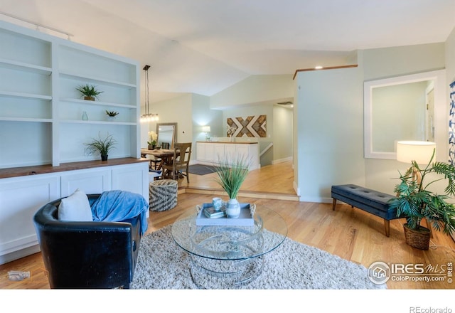 419 Centennial Dr, Louisville, CO 80027 - sitting room with wood finished floors, vaulted ceiling, and built in features