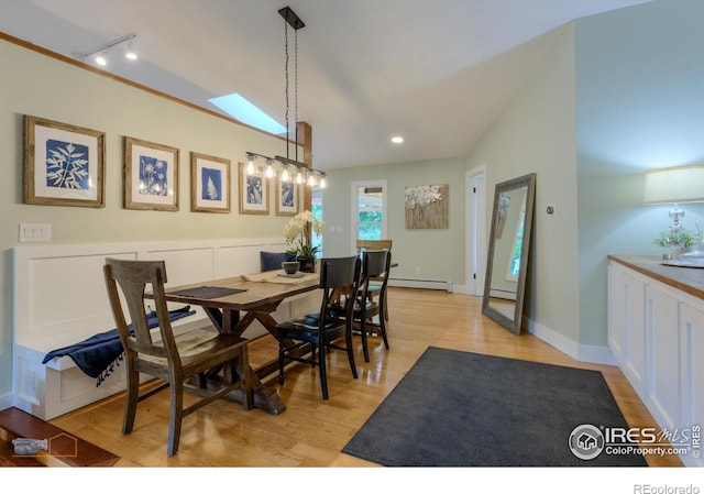 419 Centennial Dr, Louisville, CO 80027 - dining area featuring baseboard heating, rail lighting, light wood-style floors, and a skylight