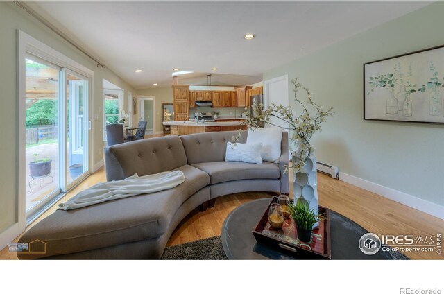 419 Centennial Dr, Louisville, CO 80027 - living area with light wood finished floors, a baseboard heating unit, and recessed lighting