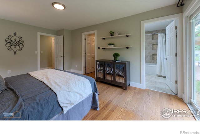 419 Centennial Dr, Louisville, CO 80027 - bedroom featuring light wood-style flooring and connected bathroom
