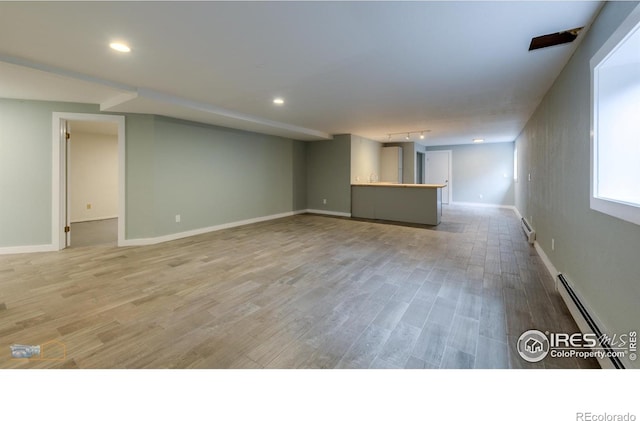 419 Centennial Dr, Louisville, CO 80027 - basement featuring a baseboard radiator, light wood finished floors, bar, and recessed lighting