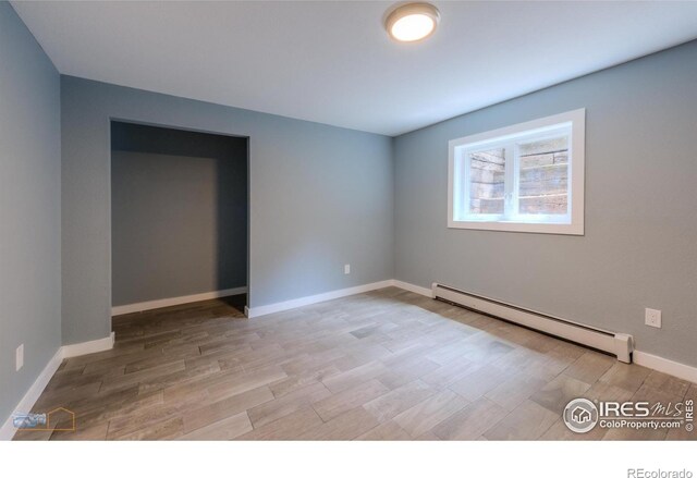 419 Centennial Dr, Louisville, CO 80027 - spare room featuring a baseboard heating unit and light wood finished floors