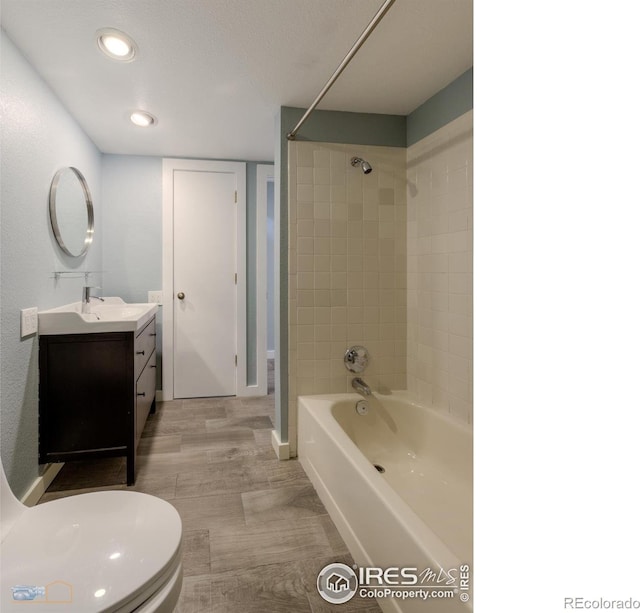 419 Centennial Dr, Louisville, CO 80027 - full bathroom featuring vanity, shower / bath combination, recessed lighting, and wood finished floors