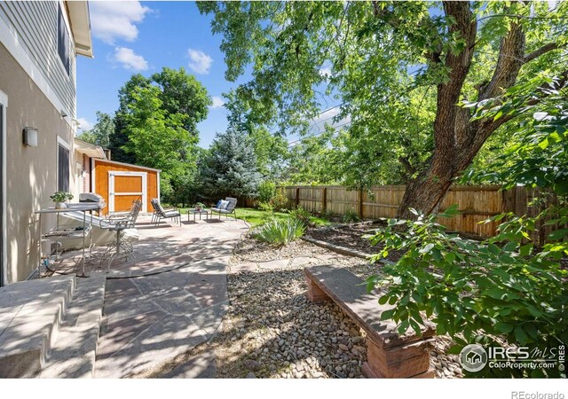 1260 Claremont Dr, Boulder, CO 80305 - fenced backyard with a patio and a storage shed