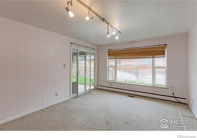 353 S Niagara St, Denver, CO 80224 - spare room with carpet, rail lighting, and a baseboard heating unit