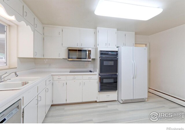 353 S Niagara St, Denver, CO 80224 - kitchen with black appliances, white cabinetry, tasteful backsplash, and light countertops