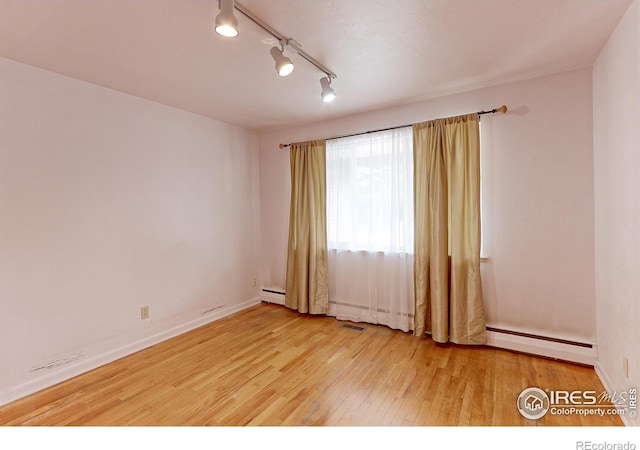 353 S Niagara St, Denver, CO 80224 - spare room featuring baseboard heating, light wood-style floors, and track lighting
