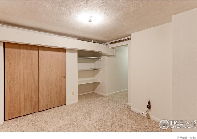 353 S Niagara St, Denver, CO 80224 - unfurnished bedroom featuring a textured ceiling, carpet, and a closet