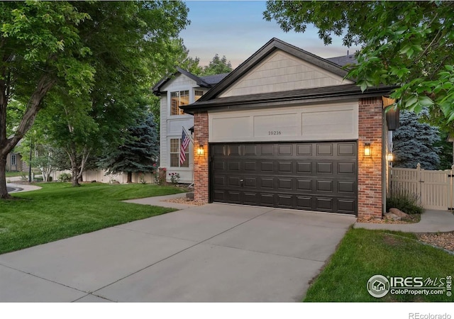10216 Sandy Ridge Ct, Firestone, CO 80504 - view of front facade featuring concrete driveway, a garage, and brick siding