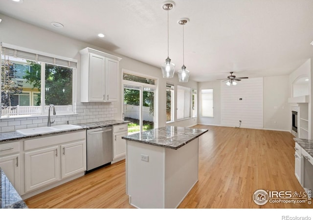 10216 Sandy Ridge Ct, Firestone, CO 80504 - kitchen with stainless steel dishwasher, healthy amount of natural light, backsplash, a ceiling fan, and recessed lighting