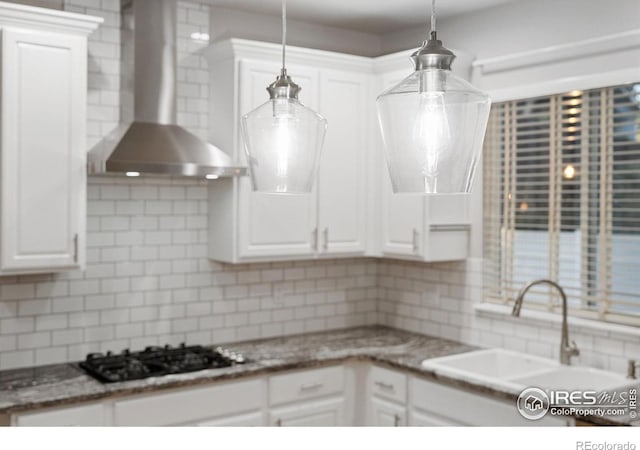 10216 Sandy Ridge Ct, Firestone, CO 80504 - kitchen with wall chimney exhaust hood, black gas stovetop, tasteful backsplash, and white cabinetry