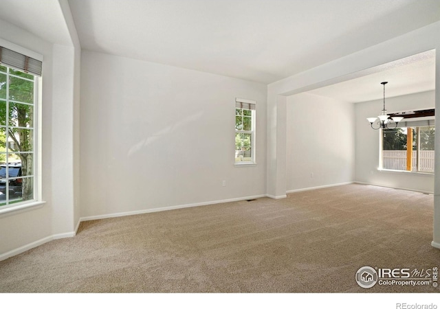 10216 Sandy Ridge Ct, Firestone, CO 80504 - carpeted empty room with a chandelier and baseboards