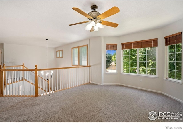 10216 Sandy Ridge Ct, Firestone, CO 80504 - carpeted empty room with ceiling fan and a chandelier
