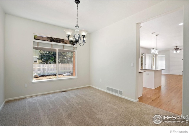 10216 Sandy Ridge Ct, Firestone, CO 80504 - spare room with a chandelier, healthy amount of natural light, carpet, and ceiling fan