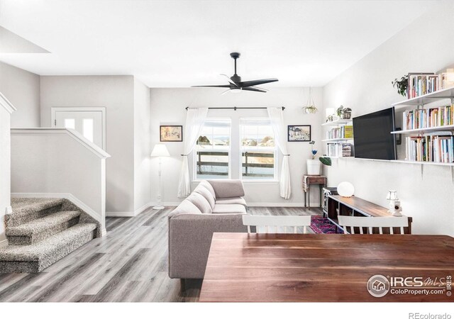 897 Winding Brook Dr, Berthoud, CO 80513 - living room with ceiling fan, wood finished floors, and stairway