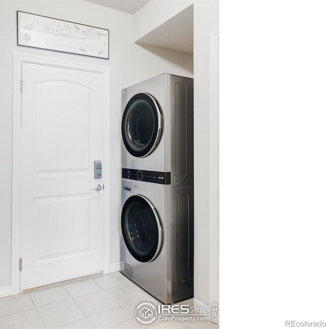897 Winding Brook Dr, Berthoud, CO 80513 - washroom featuring stacked washing machine and dryer and light tile patterned floors