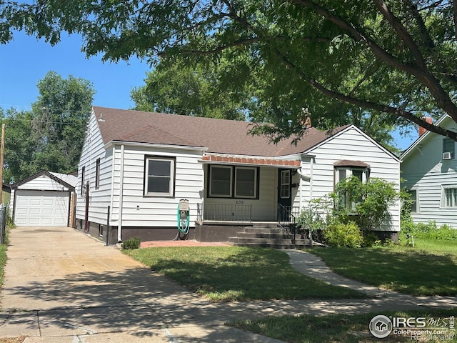 305 Euclid St, Fort Morgan, CO 80701 - bungalow-style house with an outbuilding, driveway, a detached garage, a front lawn, and a shingled roof