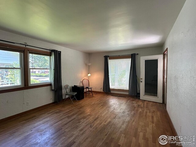 305 Euclid St, Fort Morgan, CO 80701 - unfurnished room with wood finished floors and a textured wall