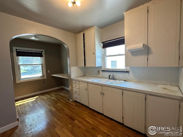 305 Euclid St, Fort Morgan, CO 80701 - kitchen with arched walkways, plenty of natural light, light countertops, and white cabinets