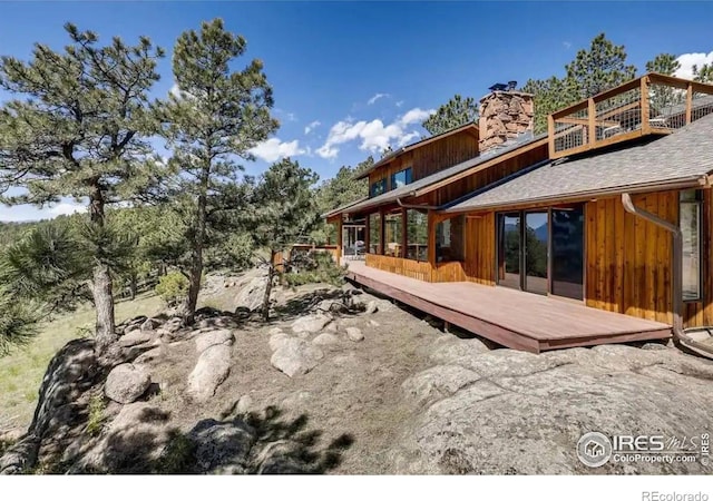 311 Sky Trail Rd, Boulder, CO 80302 - back of property with a wooden deck and a chimney