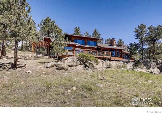 311 Sky Trail Rd, Boulder, CO 80302 - back of property with a deck and a chimney