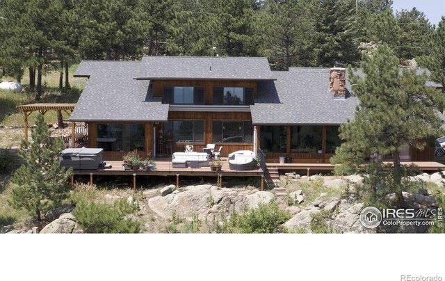 311 Sky Trail Rd, Boulder, CO 80302 - back of property with a shingled roof, a pergola, a view of trees, and a chimney