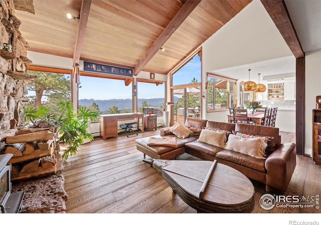 311 Sky Trail Rd, Boulder, CO 80302 - living area with a wood ceiling with exposed beams, wood-type flooring, a mountain view, a chandelier, and high vaulted ceiling
