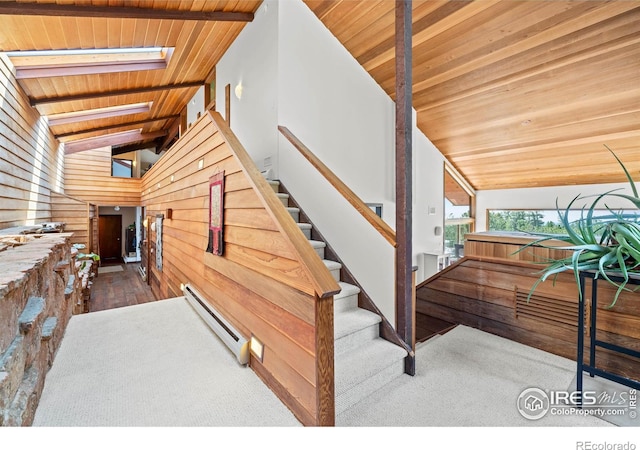 311 Sky Trail Rd, Boulder, CO 80302 - stairs featuring a baseboard radiator, wood ceiling, vaulted ceiling, a skylight, and wooden walls