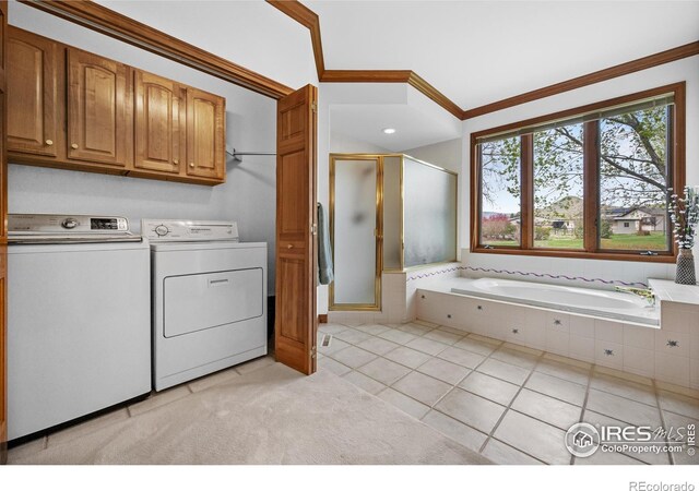 5986 Heather Way, Longmont, CO 80503 - laundry area with cabinet space, washer and dryer, crown molding, and light tile patterned floors
