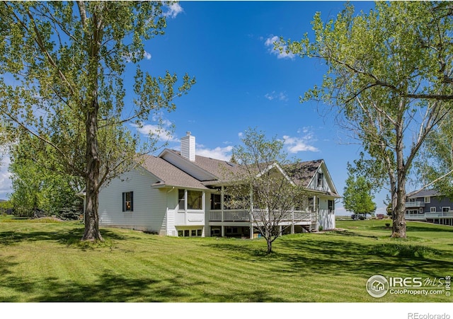 5986 Heather Way, Longmont, CO 80503 - back of property with a yard, a chimney, and a deck