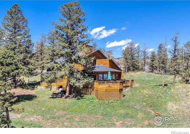 394 Deer Trail Cir, Boulder, CO 80302 - back of house featuring a deck, a yard, and a chimney