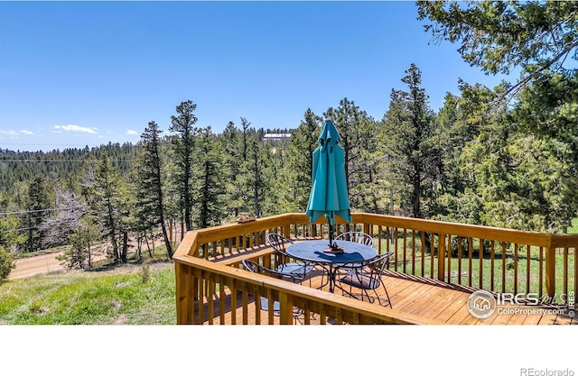 394 Deer Trail Cir, Boulder, CO 80302 - wooden terrace with a view of trees and outdoor dining area