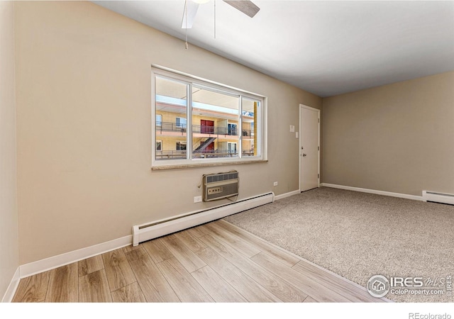 830 20th St Unit 203, Boulder, CO 80302 - unfurnished room with a baseboard heating unit, wood finished floors, ceiling fan, and an AC wall unit