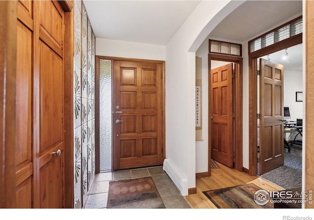 7290 Mount Sherman Rd, Longmont, CO 80503 - foyer featuring arched walkways and baseboards