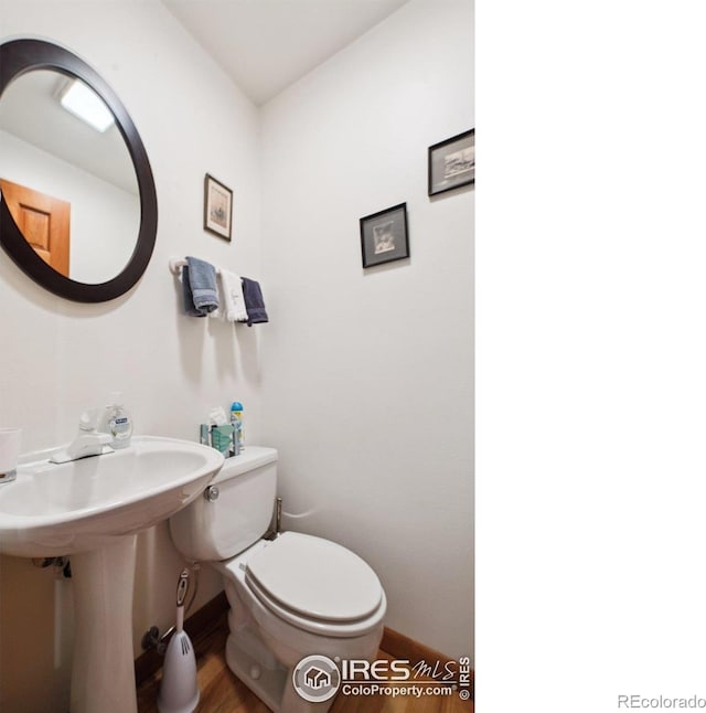 7290 Mount Sherman Rd, Longmont, CO 80503 - bathroom featuring wood finished floors and toilet