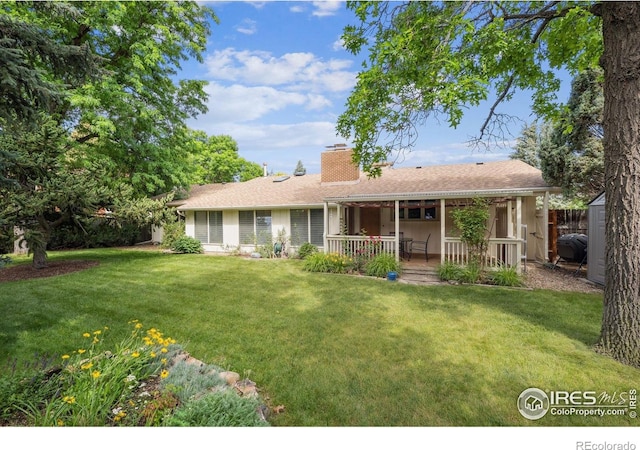 7290 Mount Sherman Rd, Longmont, CO 80503 - rear view of house with a lawn, a chimney, and covered porch
