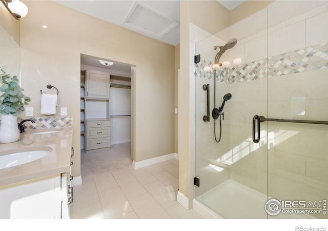 2599 Trio Falls Dr, Loveland, CO 80538 - bathroom with a shower stall, double vanity, and tile patterned flooring