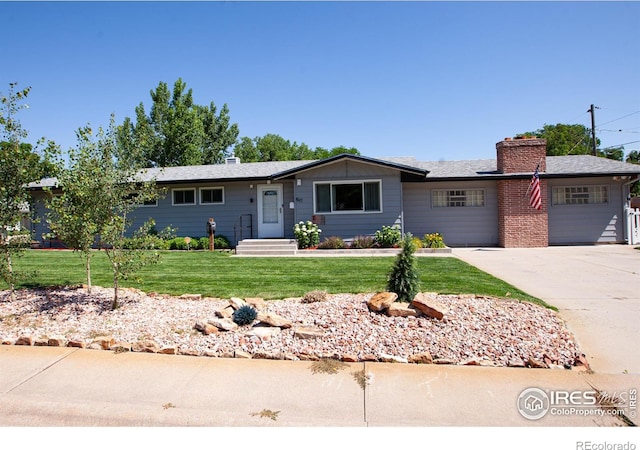 947 Holden Ln, Sterling, CO 80751 - single story home featuring a chimney, a front lawn, and concrete driveway