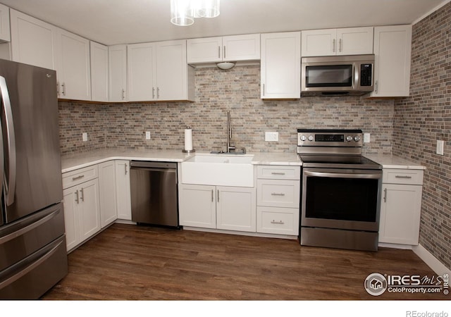 947 Holden Ln, Sterling, CO 80751 - kitchen with appliances with stainless steel finishes, light countertops, white cabinets, and tasteful backsplash