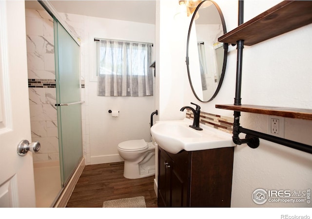 947 Holden Ln, Sterling, CO 80751 - full bath with vanity, a shower stall, and wood finished floors