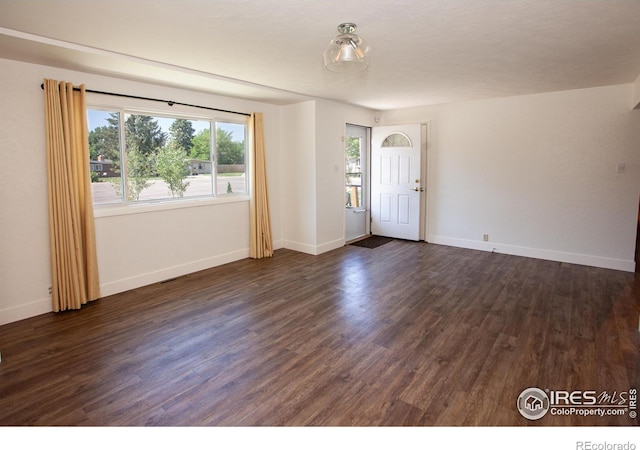 947 Holden Ln, Sterling, CO 80751 - unfurnished room featuring dark wood-type flooring and baseboards