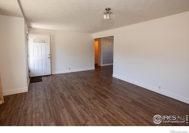 947 Holden Ln, Sterling, CO 80751 - empty room with baseboards and dark wood-style floors
