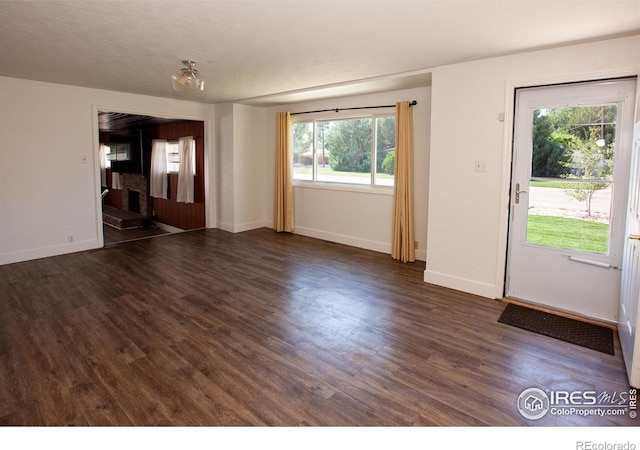 947 Holden Ln, Sterling, CO 80751 - unfurnished living room with plenty of natural light and dark wood-style floors