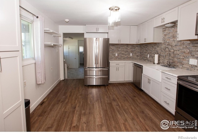 947 Holden Ln, Sterling, CO 80751 - kitchen featuring appliances with stainless steel finishes, white cabinets, backsplash, and light countertops