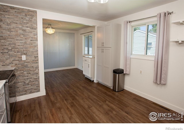 947 Holden Ln, Sterling, CO 80751 - unfurnished dining area with dark wood-style flooring