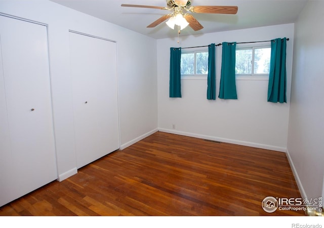 947 Holden Ln, Sterling, CO 80751 - unfurnished bedroom with wood finished floors and ceiling fan
