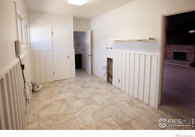 947 Holden Ln, Sterling, CO 80751 - spare room with wainscoting and a fireplace
