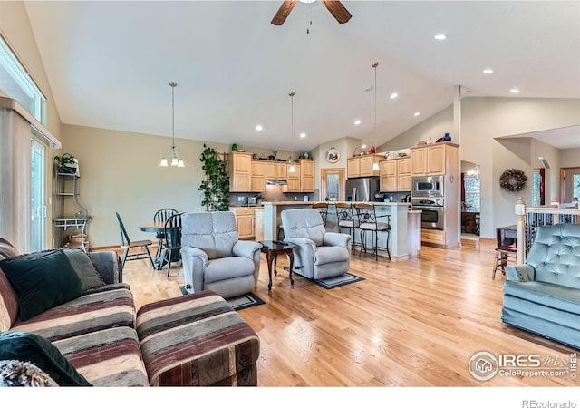 9629 Bountiful St, Firestone, CO 80504 - living room featuring ceiling fan, light wood-style floors, high vaulted ceiling, a chandelier, and recessed lighting